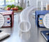 Red and blue binders with checklists under magnifying glasses on a stainless lab bench