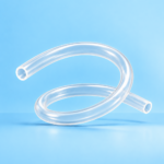 Clear flexible tubing curled into a loose spiral against a blue background.