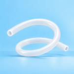 Clear flexible silicone tubing coiled on a blue background.